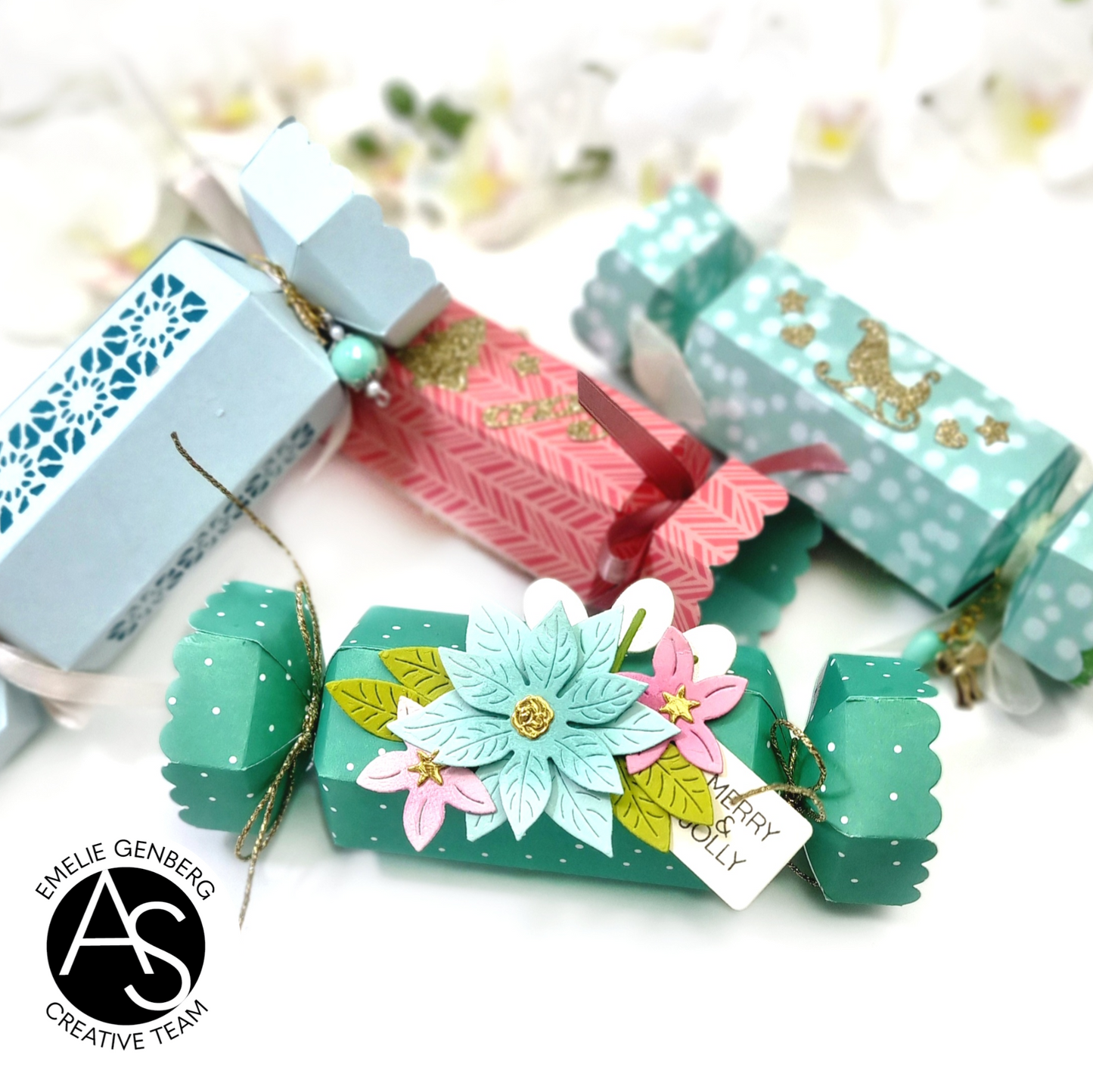 Christmas-themed gift boxes with decorative ribbons and text on a festive background.Alex_Syberia_Christmas_Cracker_die and christmas Jokes stamp