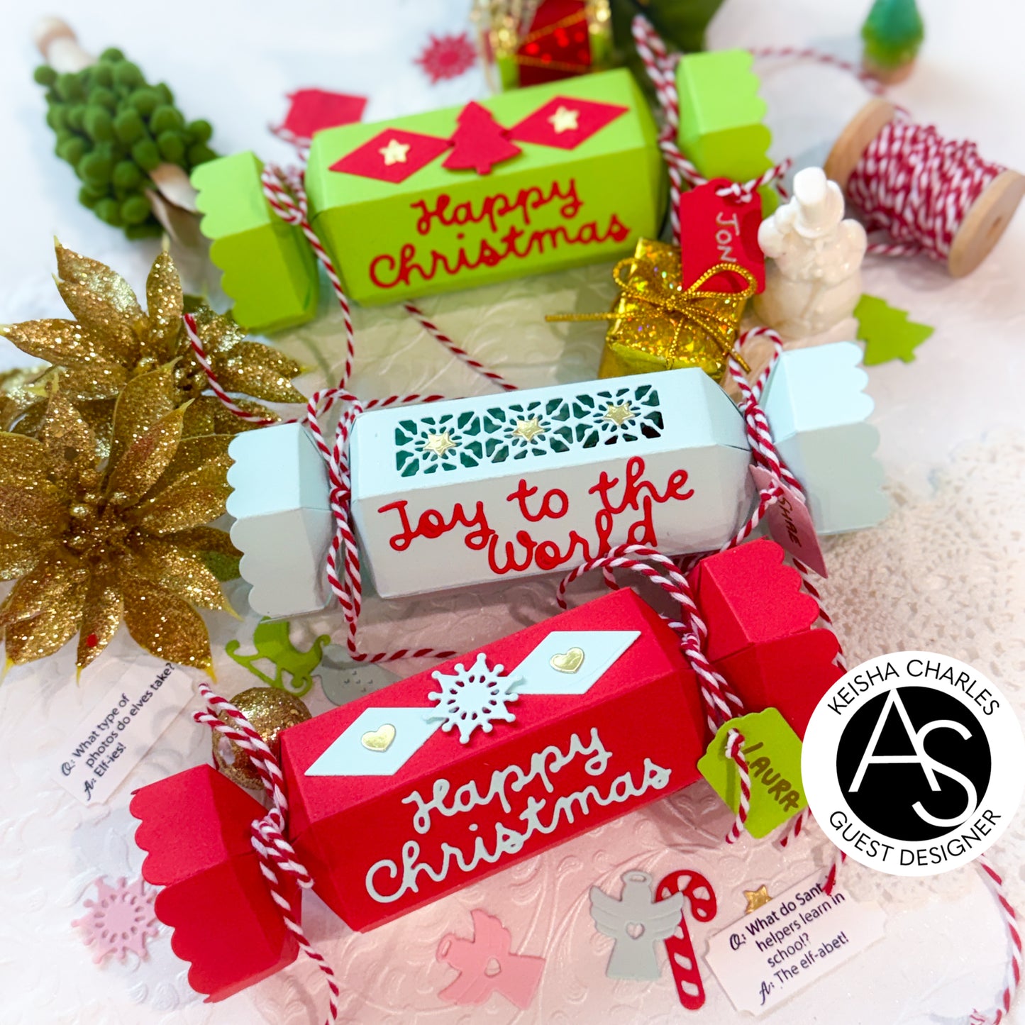 Christmas-themed gift boxes with decorative ribbons and text on a festive background.Alex_Syberia_Christmas_Cracker_die and christmas Jokes stamp