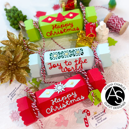 Christmas-themed gift boxes with decorative ribbons and text on a festive background.Alex_Syberia_Christmas_Cracker_die and christmas Jokes stamp